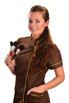 Professional beautician holding brushes