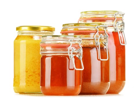 Composition with jars of honey isolated on white background
