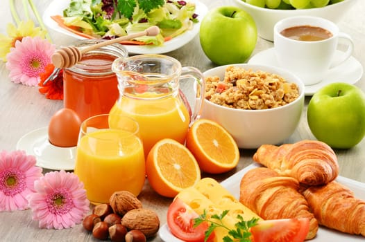 Breakfast consisting of fruits, orange juice, coffee, honey, bread and egg. Balanced diet