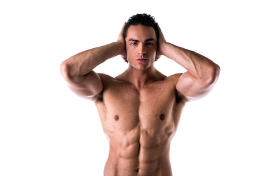 Muscular shirtless young man covering ears with hands, isolated on white