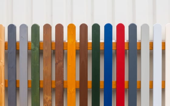 Colorful fence with wooden slats in different colors.