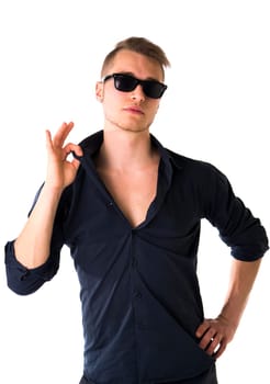 Cool confident blond young man with sunglasses and blue shirt, isolated on white