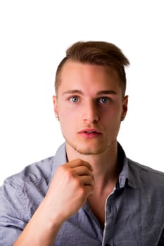 Handsome young man with aggressive, challenging expression, isolated on white