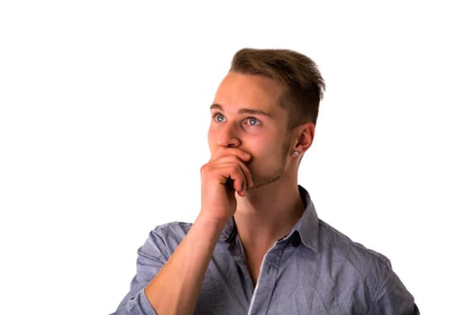 Dubious, unsure handsome blond young man isolated on white