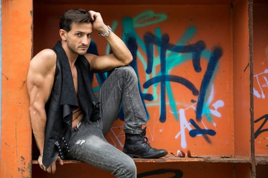 Handsome man outdoor in urban environment looking at camera