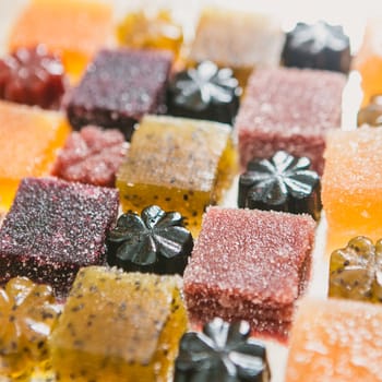 Many different fruit paste candies. Whole background. Selective focus. warm colors