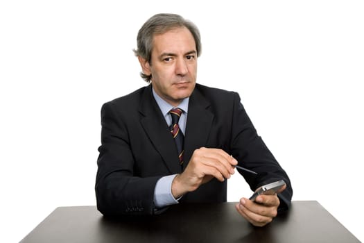 mature business man on a desk, isolated on white