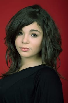 young woman portrait isolated on red background