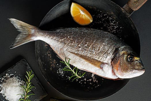 Delicious fresh fish on dark vintage background. Healthy food diet or cooking concept