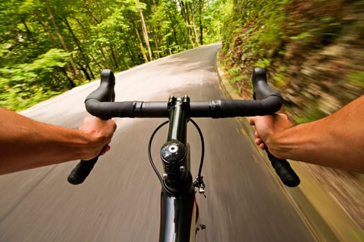 Cyclist riding a bike on the road in nature