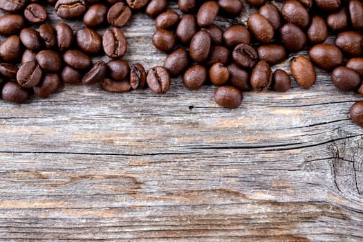 brown roasted coffee beans on wooden ground