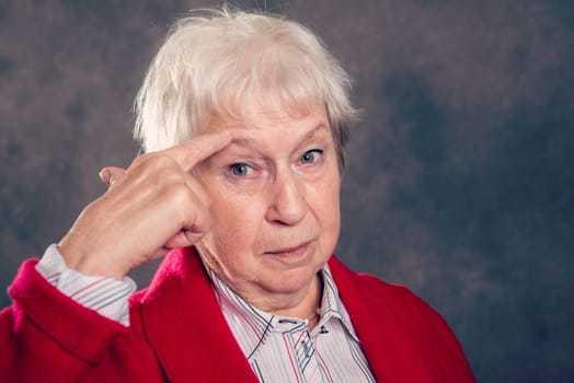 gray hairy elderly woman looking angry and showing a bird