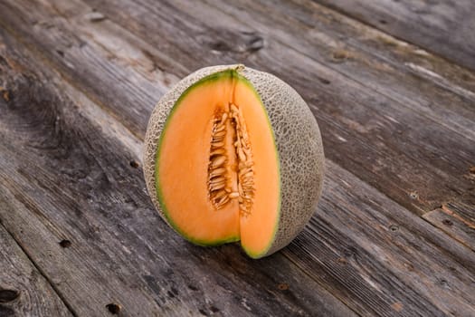 fresh sweet cantaloupe melon on wooden ground