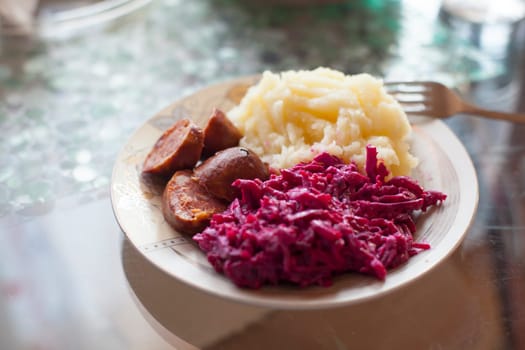 Meat sausage with potato puree and salad of beet