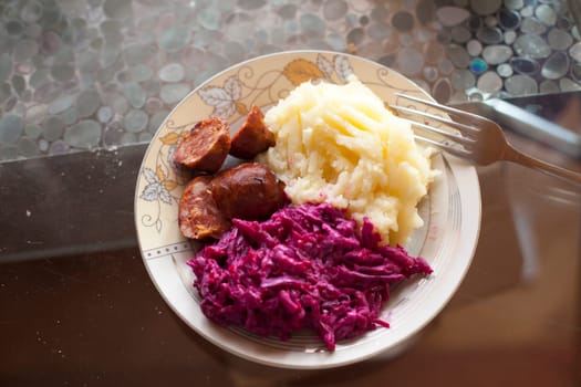 Meat sausage with potato puree and salad of beet