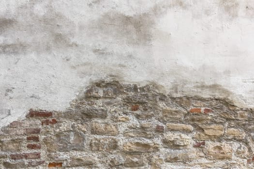 Old bricks with partial white plastered wall texture