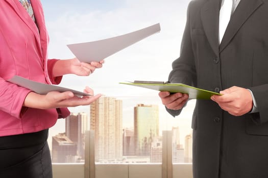 Business people with files discussing something in the office