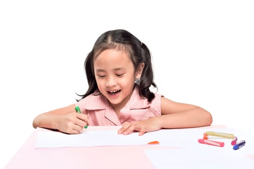 Portrait of asian little girl drawing with colorful crayon isolated over white background