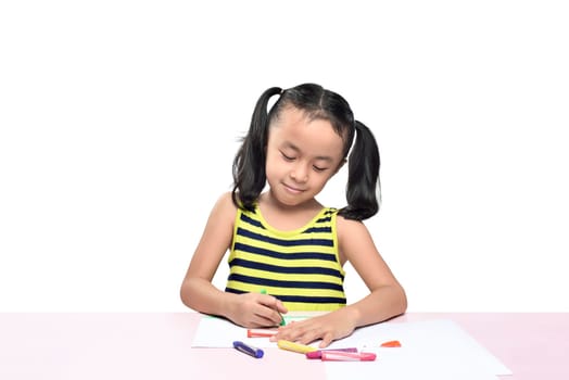 Cute asian little girl drawing on the table isolated over white background