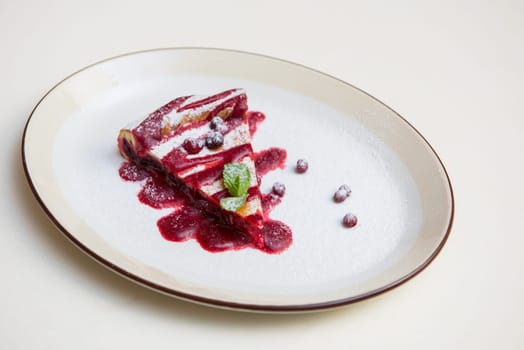 tasty cake with cowberry and fresh mint
