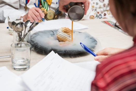 Tasting and evaluation of food by a certified specialist. A professional taster assesses the dessert