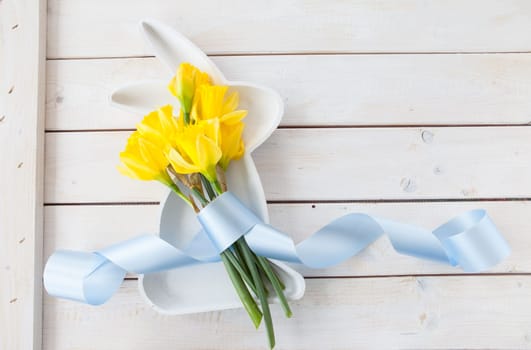 Fresh daffodils at Easter on a wooden background