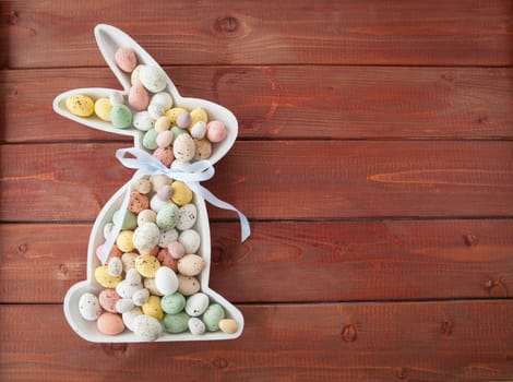 Colorful Easter eggs made of chocolate on rustic wood background