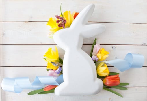 Easter bunny with fresh flowers in Spring