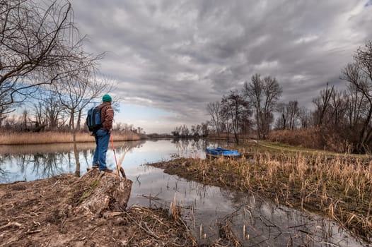 Hiker resting on river bank. Hike and people concept, travel,tourism.