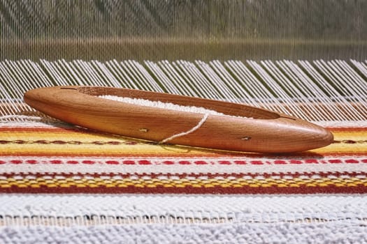 Wooden Shuttle with Bobbin on the Weft Yarn (Shallow DoF)
