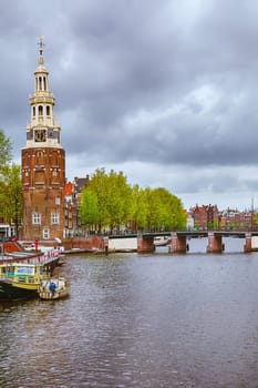 Tower (Montelbaanstoren) on the Bank of the Canal Oudeschans in Amsterdam, Netherlands