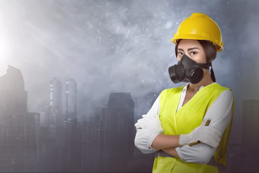 Beautiful asian woman engineer with protective mask against city background