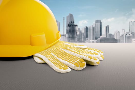 Construction worker equipment like hard hat and gloves on the table