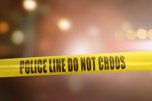 Yellow police line tape sign for protection crime scene with blurred light background
