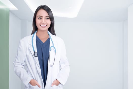 Cheerful asian doctor woman with stethoscope on hospital room
