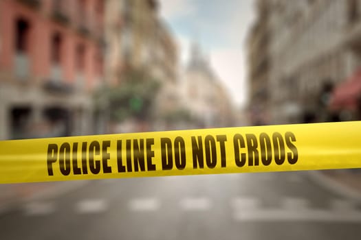 Yellow police line tape with text Police Line Do Not Cross against blurred city background