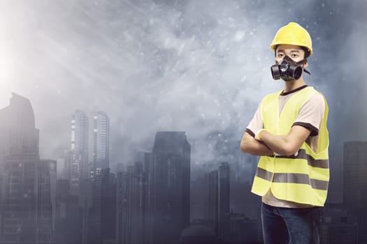 Attractive asian construction worker with protective mask over cityscape background