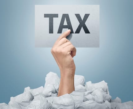 People hand holding paper with Tax sign over bright background