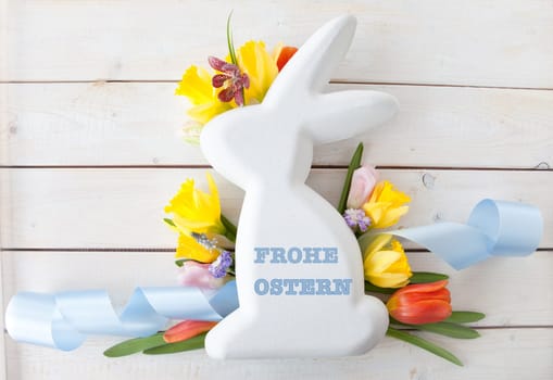 Easter bunny with fresh flowers in Spring