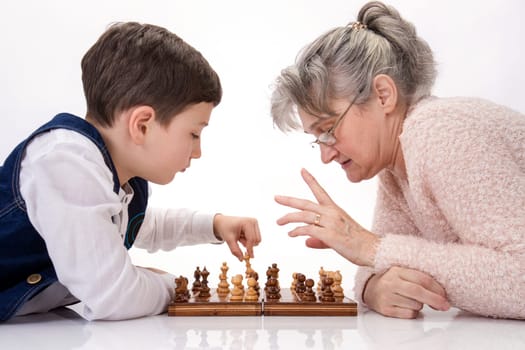 Grandma and nephew face to face playing chess