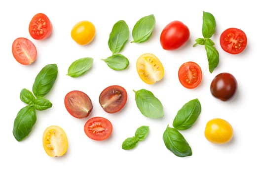 tomatoes and basil leaves isolated on white background. top view