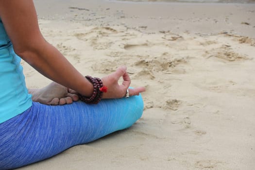 yoga lotus position on beach background copy space  calm relaxed beach wave
