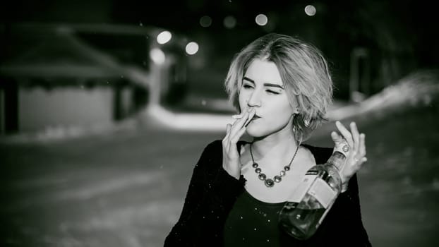 Black and white portrait of a girl with a cigarette. young beautiful woman with dyed hair smoking a cigarette in the street under the snow