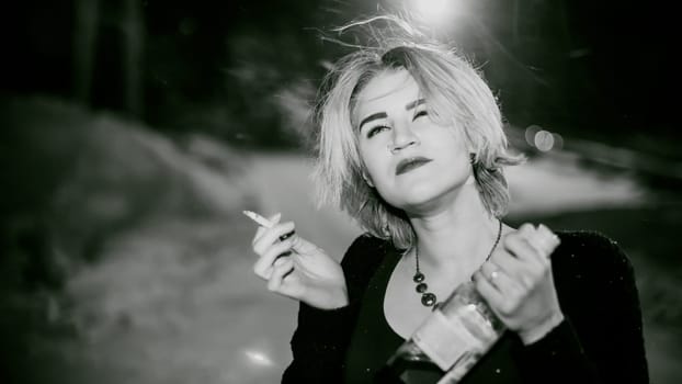 Black and white portrait of a girl with a cigarette. young beautiful woman with dyed hair smoking a cigarette in the street under the snow