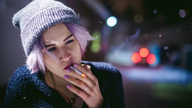 Portrait of a girl with a cigarette. young beautiful girl with dyed hair hipster hat. cigarette smoking on the street under the snow