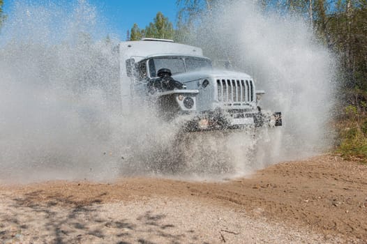 the truck passes through a puddle