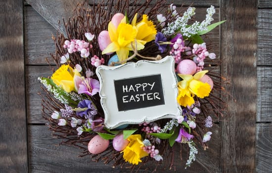 Colorful wreath of twigs and flowers for Easter