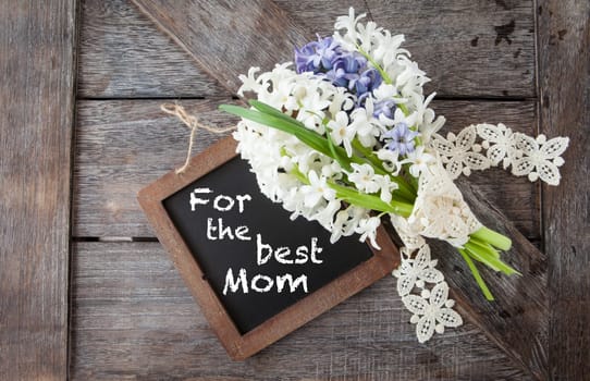 Little bunch of white and blue hyacinths on rustic wooden background