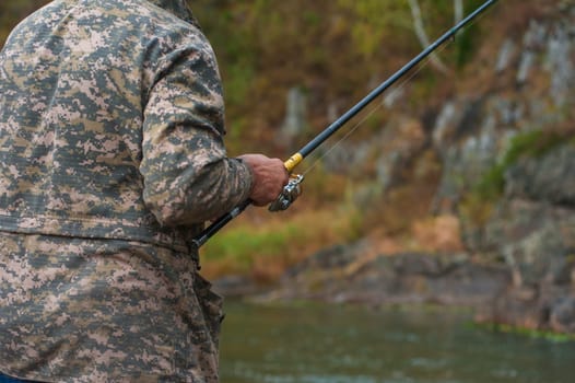 Fisherman at the Altai river, closeup photo