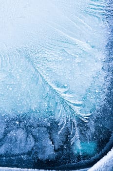Iceflowers, frozen.The ice-cold frost forms ice crystals in beautiful unique patterns on the window, Hood and wiper on the Car
